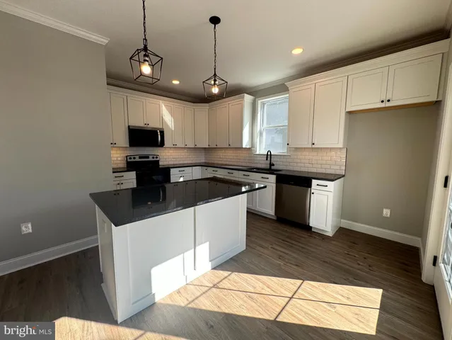 a bathroom with a sink a toilet a mirror and shower