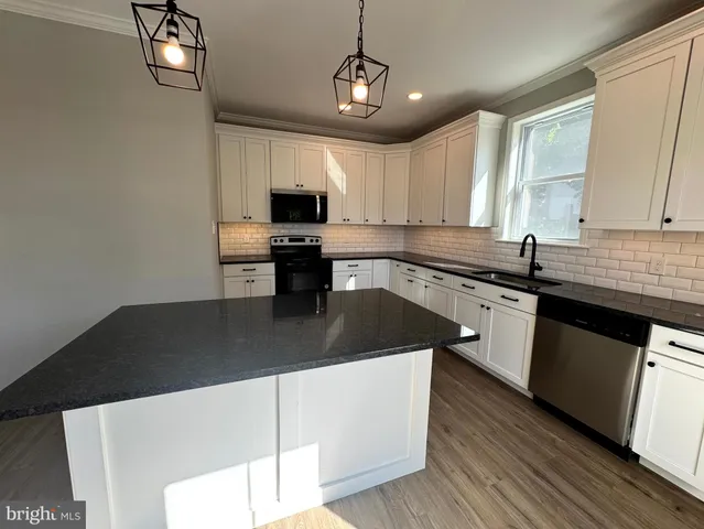 a bathroom with a double vanity sink toilet mirror and shower