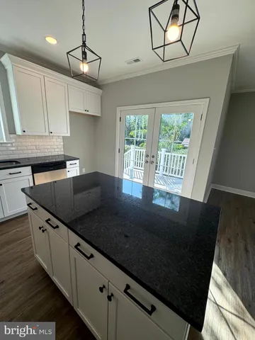 an empty room with a window and wooden floor