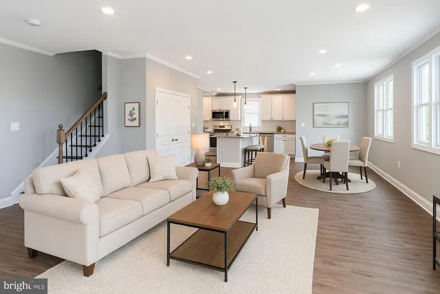 a kitchen with stainless steel appliances granite countertop a sink a stove a microwave a center island and cabinets