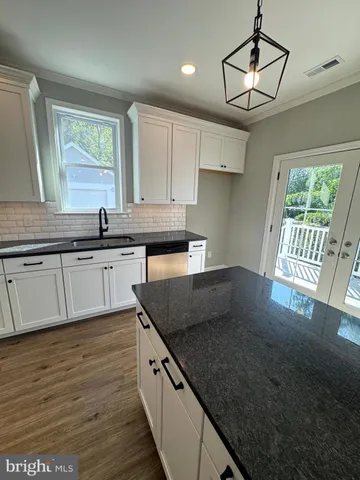an empty room with wooden floor and window