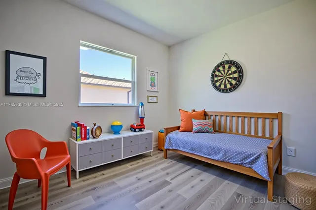 a bedroom with furniture and a chair