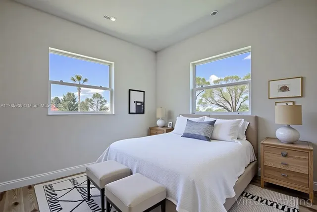 a bedroom with a bed and a painting on the wall