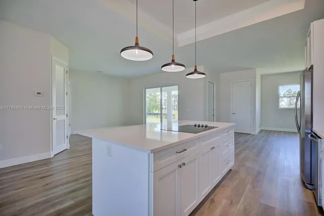 a kitchen with sink cabinets and wooden floor