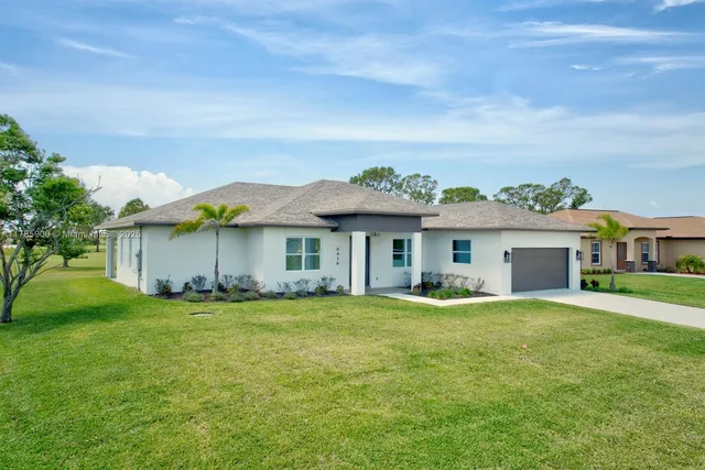 a view of a house with a yard and a porch