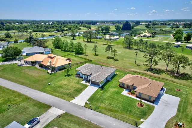 an aerial view of multiple houses with yard