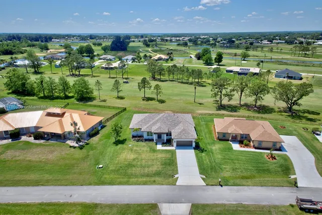 an aerial view of multiple houses with a yard