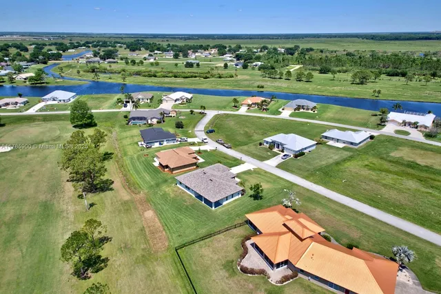 an aerial view of a residential houses with outdoor space and street view