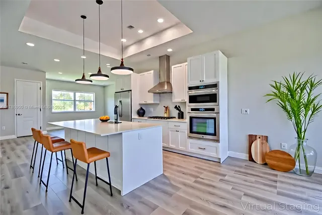 a kitchen with stainless steel appliances granite countertop a stove a sink and a refrigerator