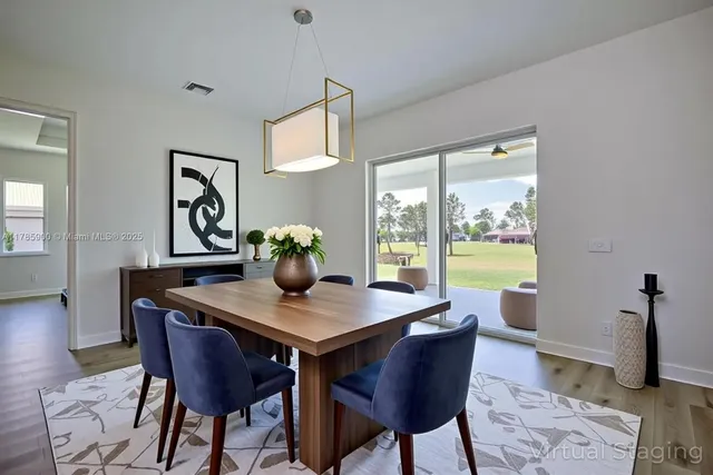 a view of a dining room that has a table and chairs in it