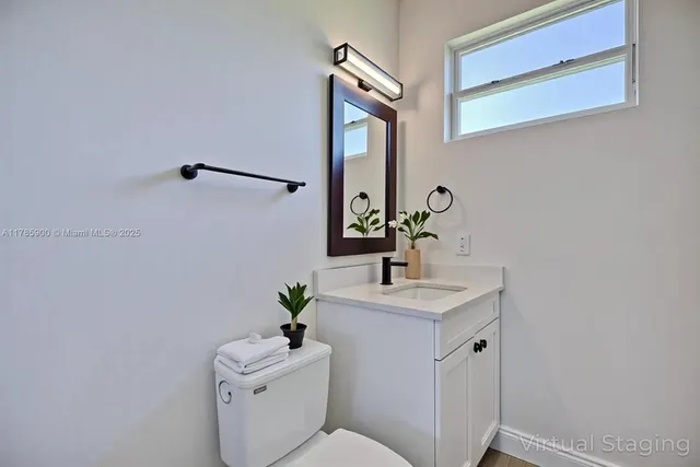 a bathroom with a toilet sink and mirror