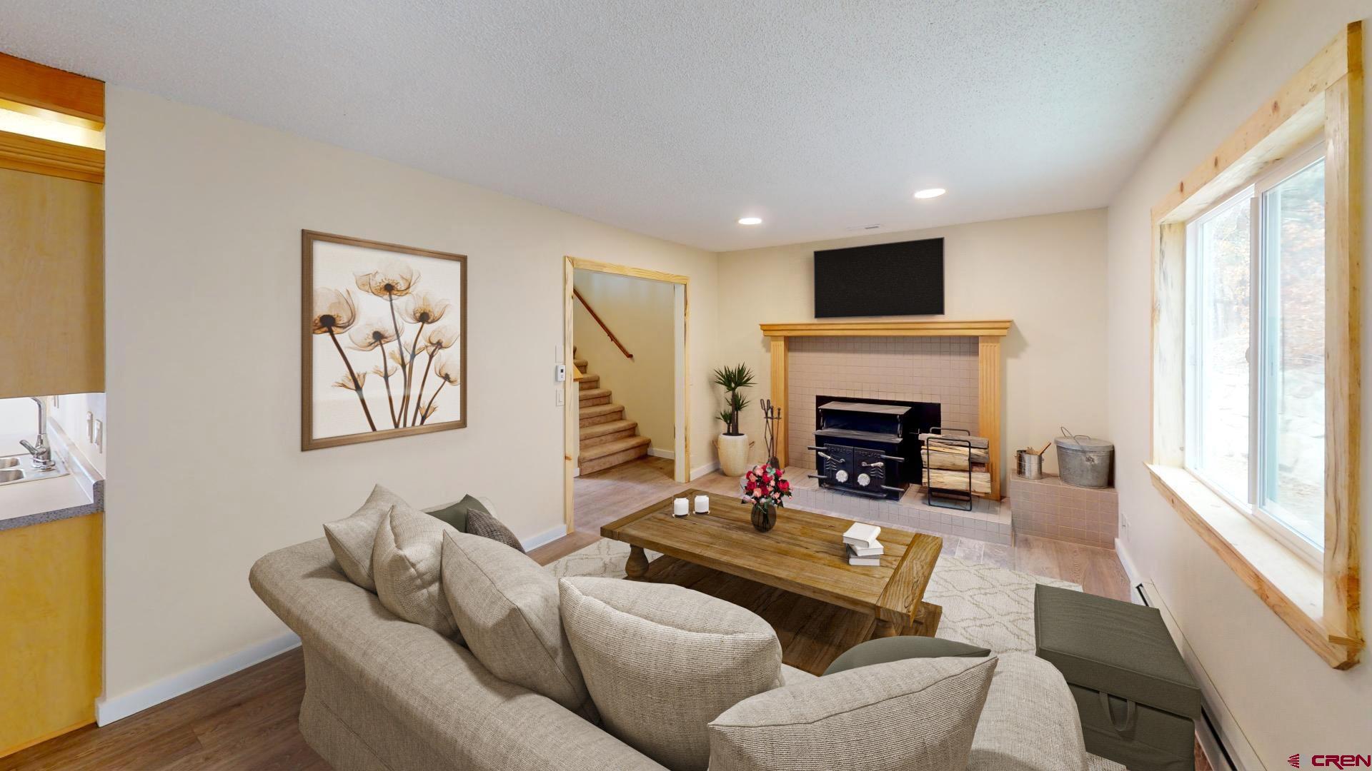 356 County Road 201 Durango, CO 81301 - Photo 12 of 35 a living room with furniture a flat screen tv and a fireplace