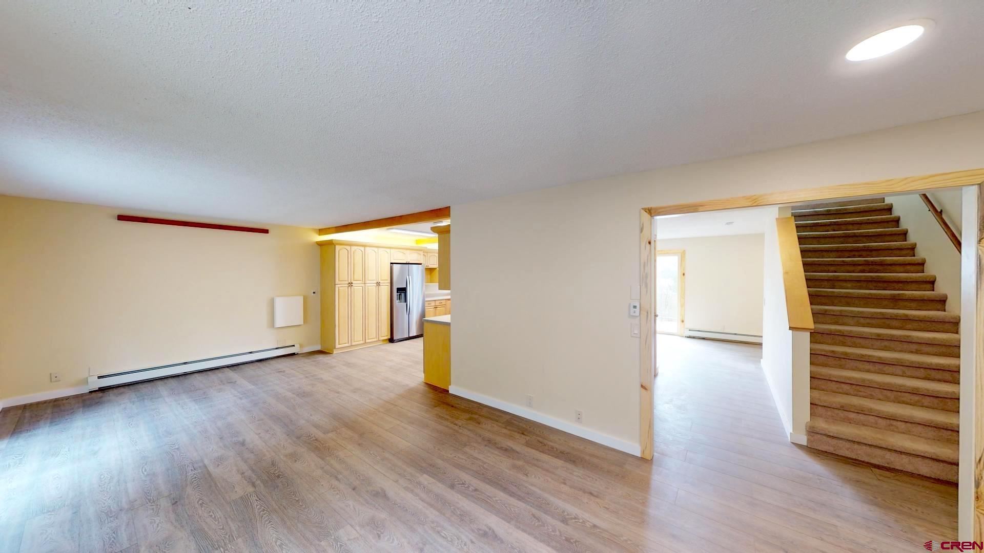 356 County Road 201 Durango, CO 81301 - Photo 13 of 35 a view of an empty room with wooden floor and a window