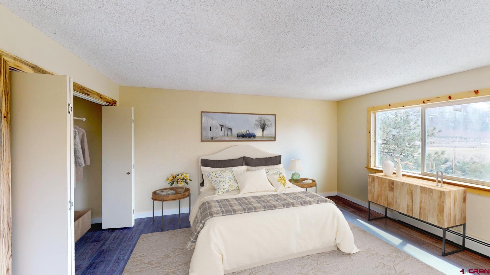 356 County Road 201 Durango, CO 81301 - Photo 16 of 35 a bedroom with a bed and wooden floor