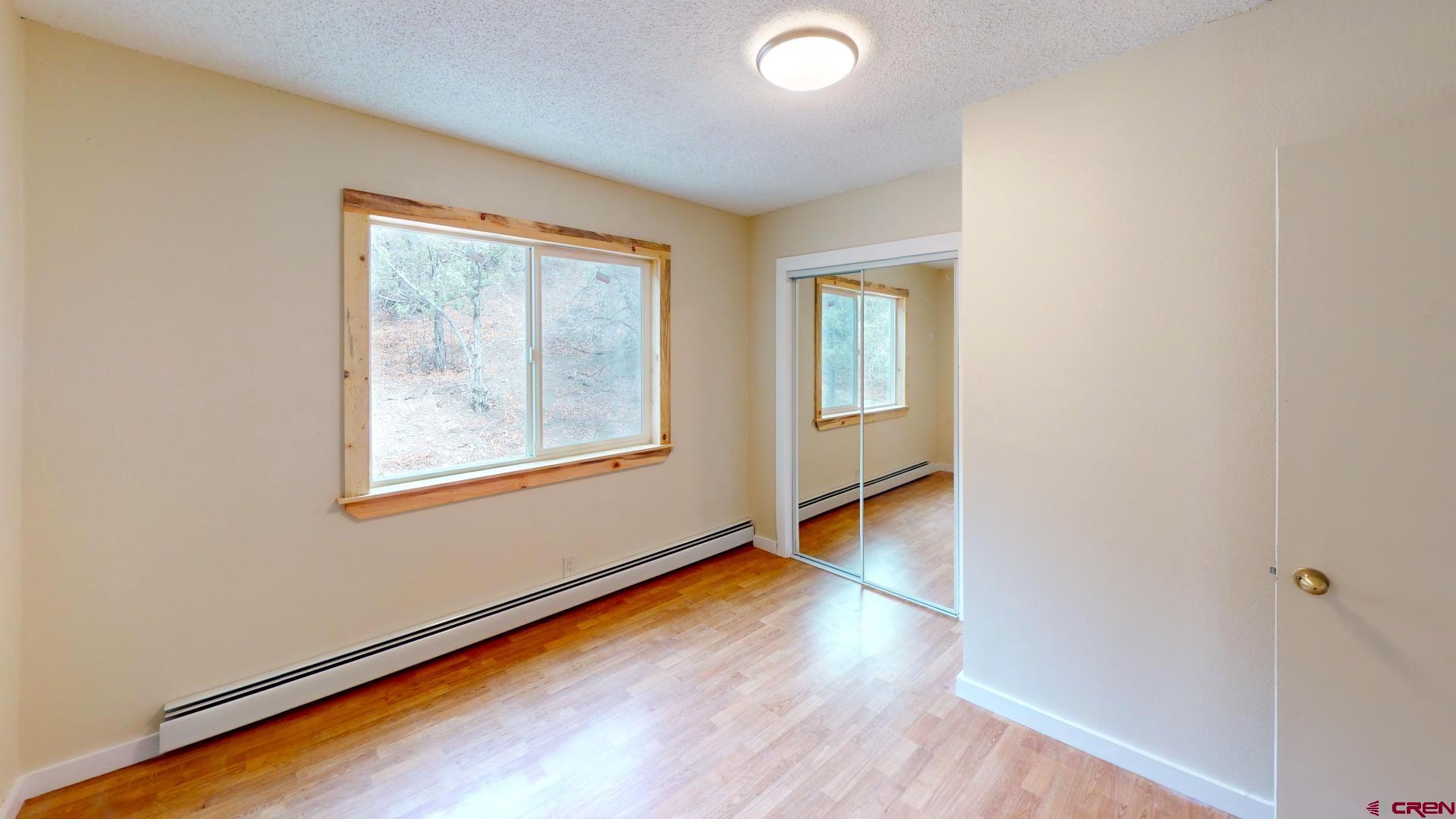 356 County Road 201 Durango, CO 81301 - Photo 20 of 35 an empty room with wooden floor and windows
