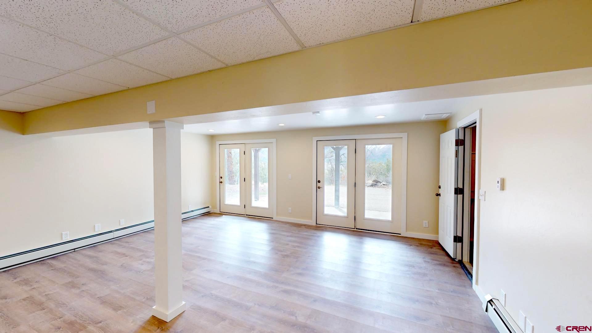 356 County Road 201 Durango, CO 81301 - Photo 4 of 35 a view of an empty room with wooden floor and a window
