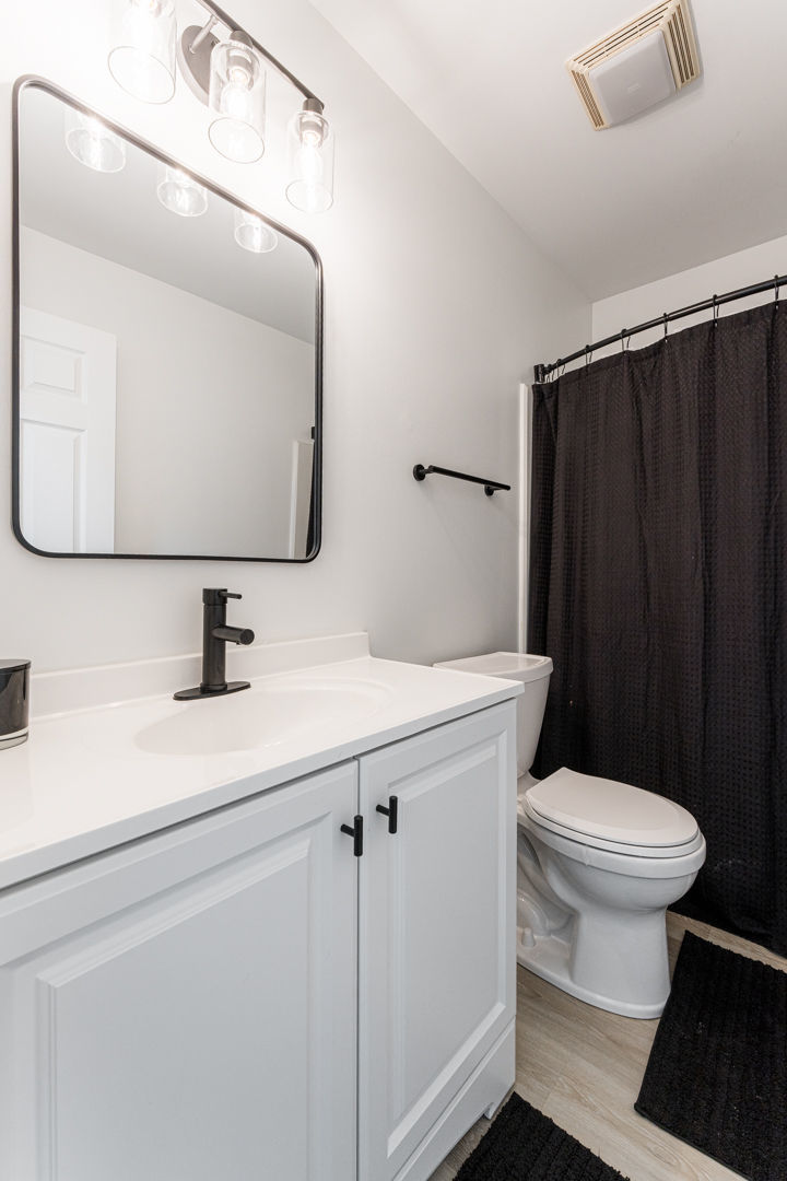 2117 Frantum Road Sycamore, IL 60178 - Photo 18 of 24 a bathroom with a sink a toilet a mirror and vanity