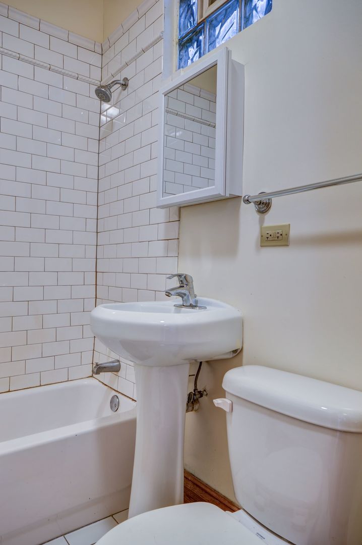 3722 North Fremont Street, Unit 2 Chicago, IL 60613 - Photo 15 of 16 a bathroom with a sink a toilet and bathtub