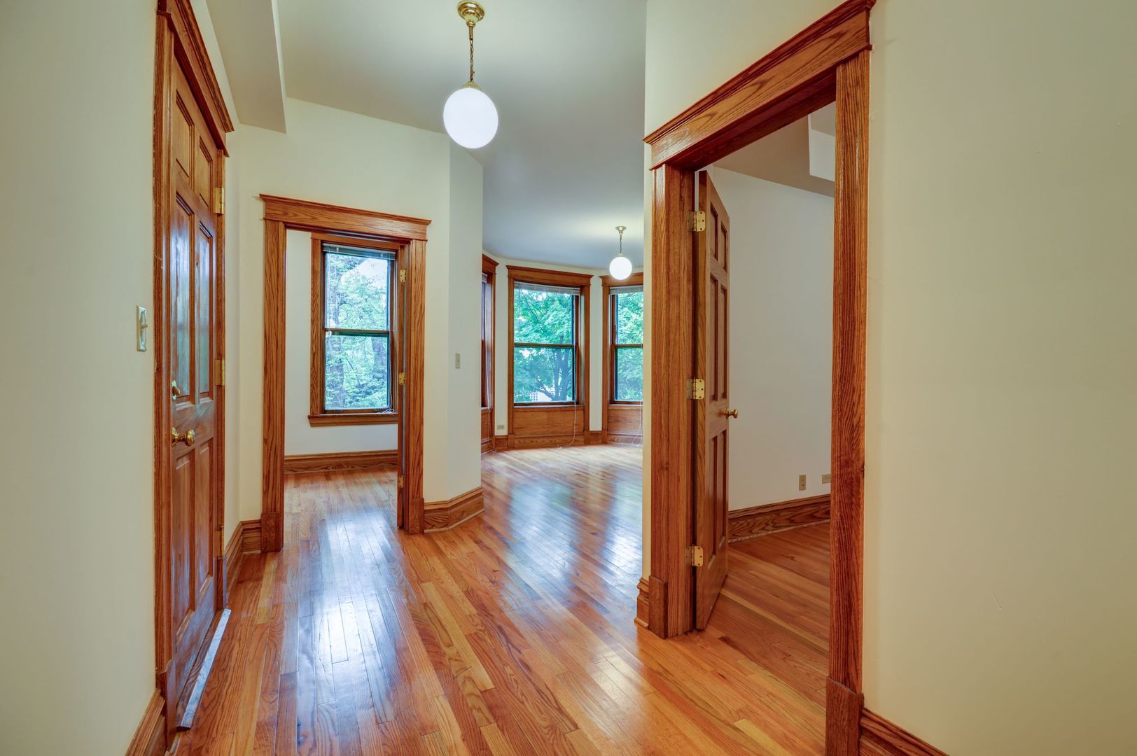 3722 North Fremont Street, Unit 2 Chicago, IL 60613 - Photo 2 of 16 a view of a hallway with wooden floor and staircase