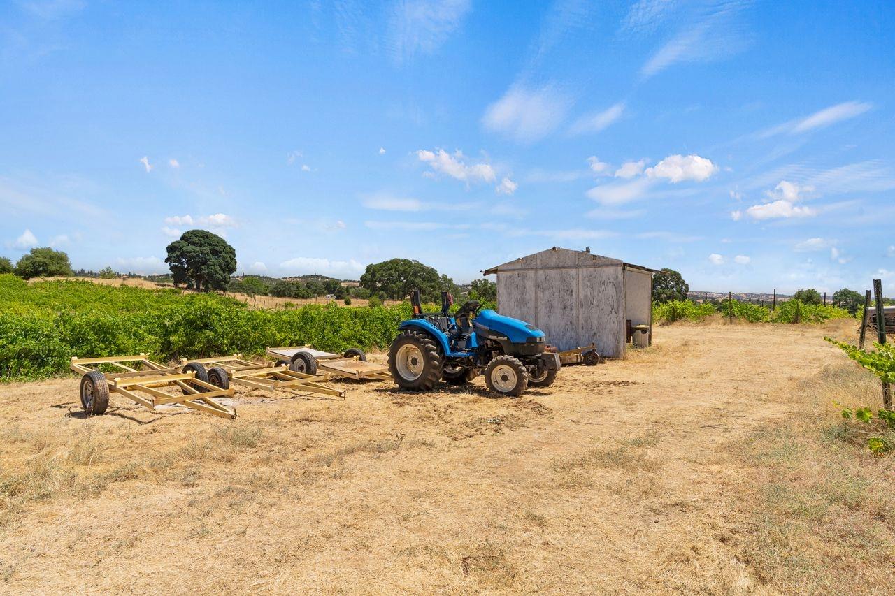21226 Dickson Road Plymouth, CA 95669 - Photo 23 of 36 a view of a backyard with table and chairs and couches under an umbrella