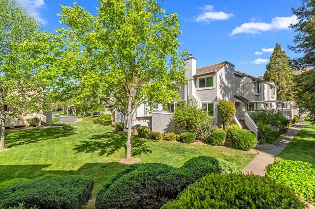 a view of a house with a yard and sitting area
