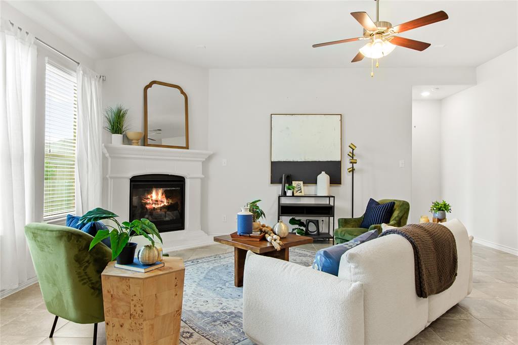 3100 Rademaker Drive Heath, TX 75126 - Photo 12 of 26 a living room with furniture a fireplace and a potted plant