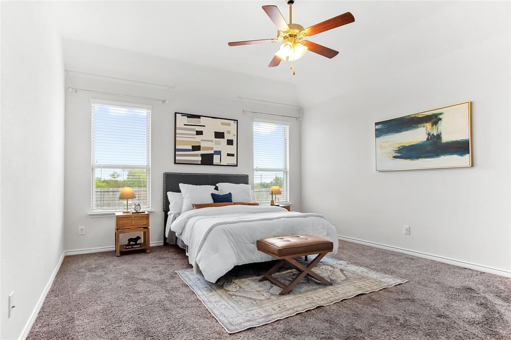 3100 Rademaker Drive Heath, TX 75126 - Photo 13 of 26 a bedroom with a bed and a chandelier