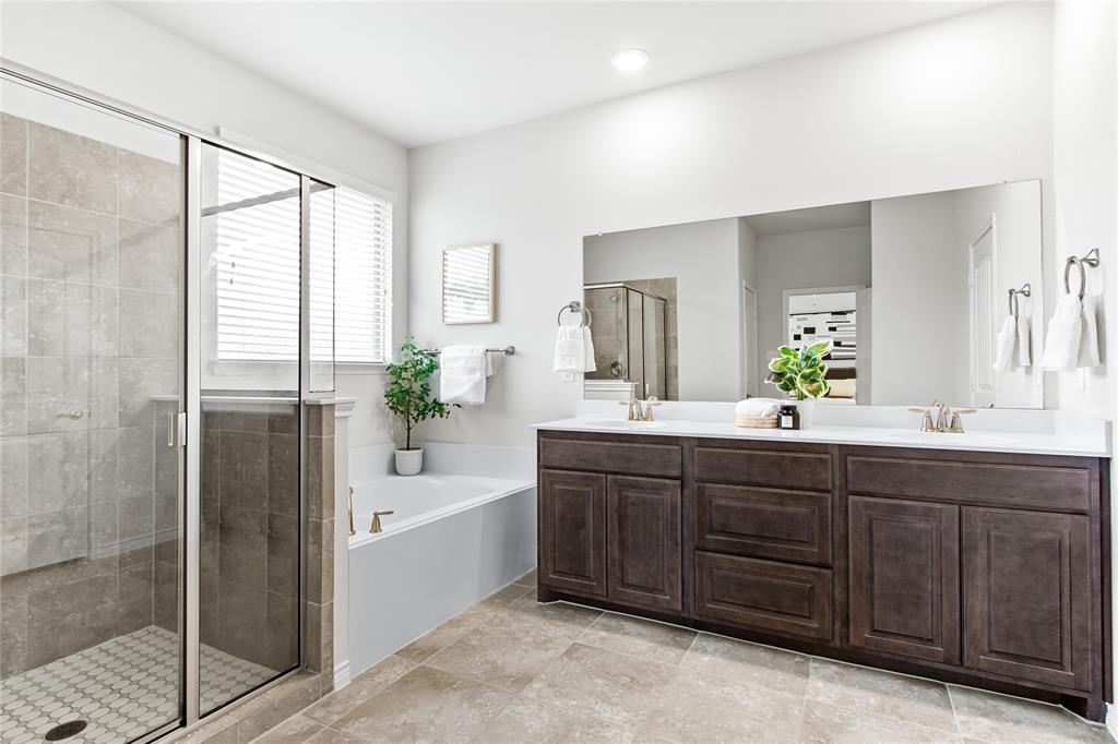 3100 Rademaker Drive Heath, TX 75126 - Photo 14 of 26 a spacious bathroom with a tub sink and mirror