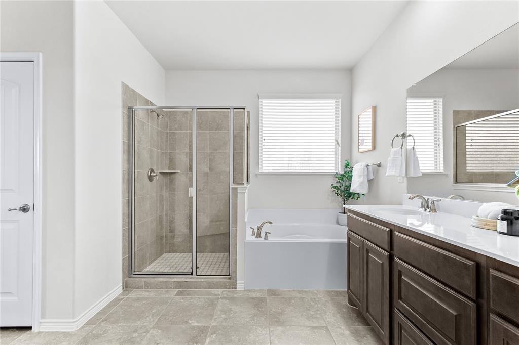 3100 Rademaker Drive Heath, TX 75126 - Photo 15 of 26 a bathroom with a tub sink and mirror