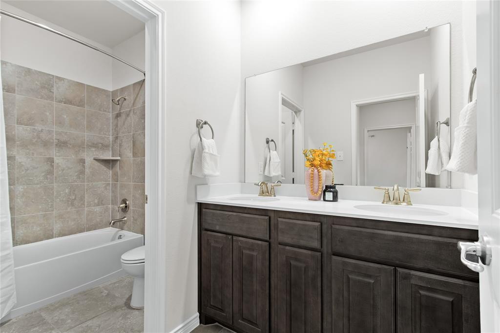 3100 Rademaker Drive Heath, TX 75126 - Photo 19 of 26 a bathroom with a sink a toilet and shower