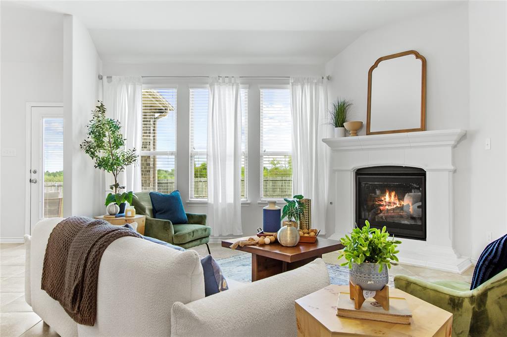 3100 Rademaker Drive Heath, TX 75126 - Photo 3 of 26 a living room with furniture potted plant and a fireplace