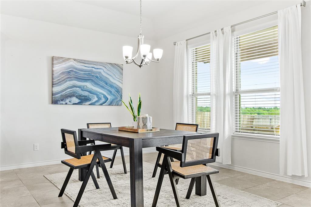 3100 Rademaker Drive Heath, TX 75126 - Photo 4 of 26 a view of a dining room with furniture a chandelier and wooden floor