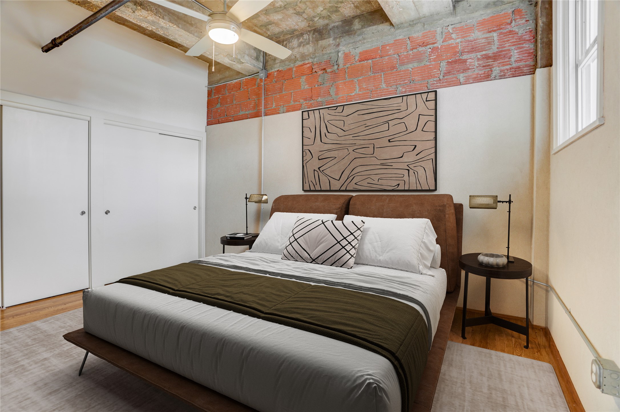 204 Travis Street, Unit 4D Houston, TX 77002 - Photo 6 of 22 a bedroom with a bed and a painting on the wall