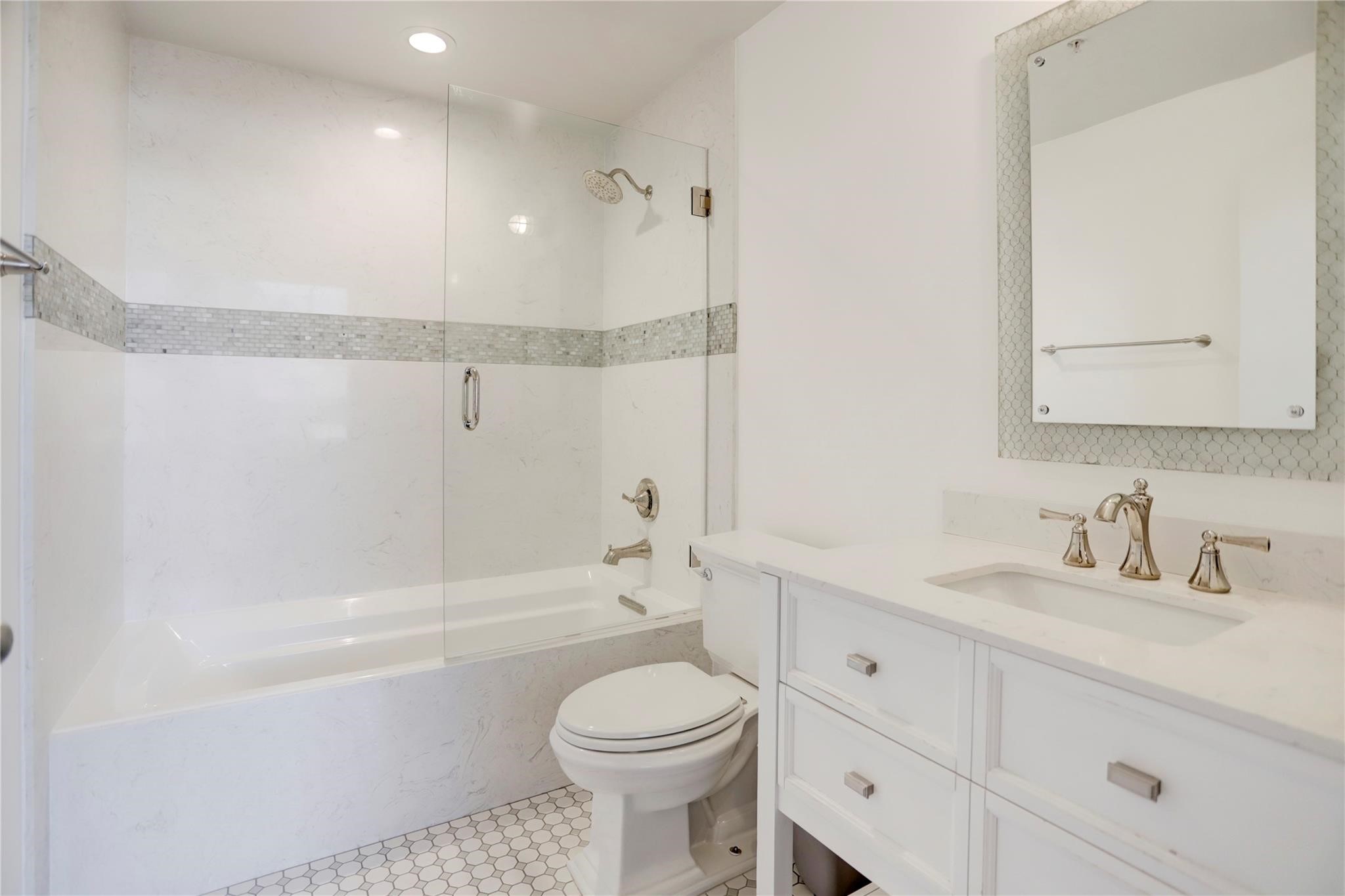 204 Travis Street, Unit 4D Houston, TX 77002 - Photo 8 of 22 a bathroom with a sink a toilet and shower