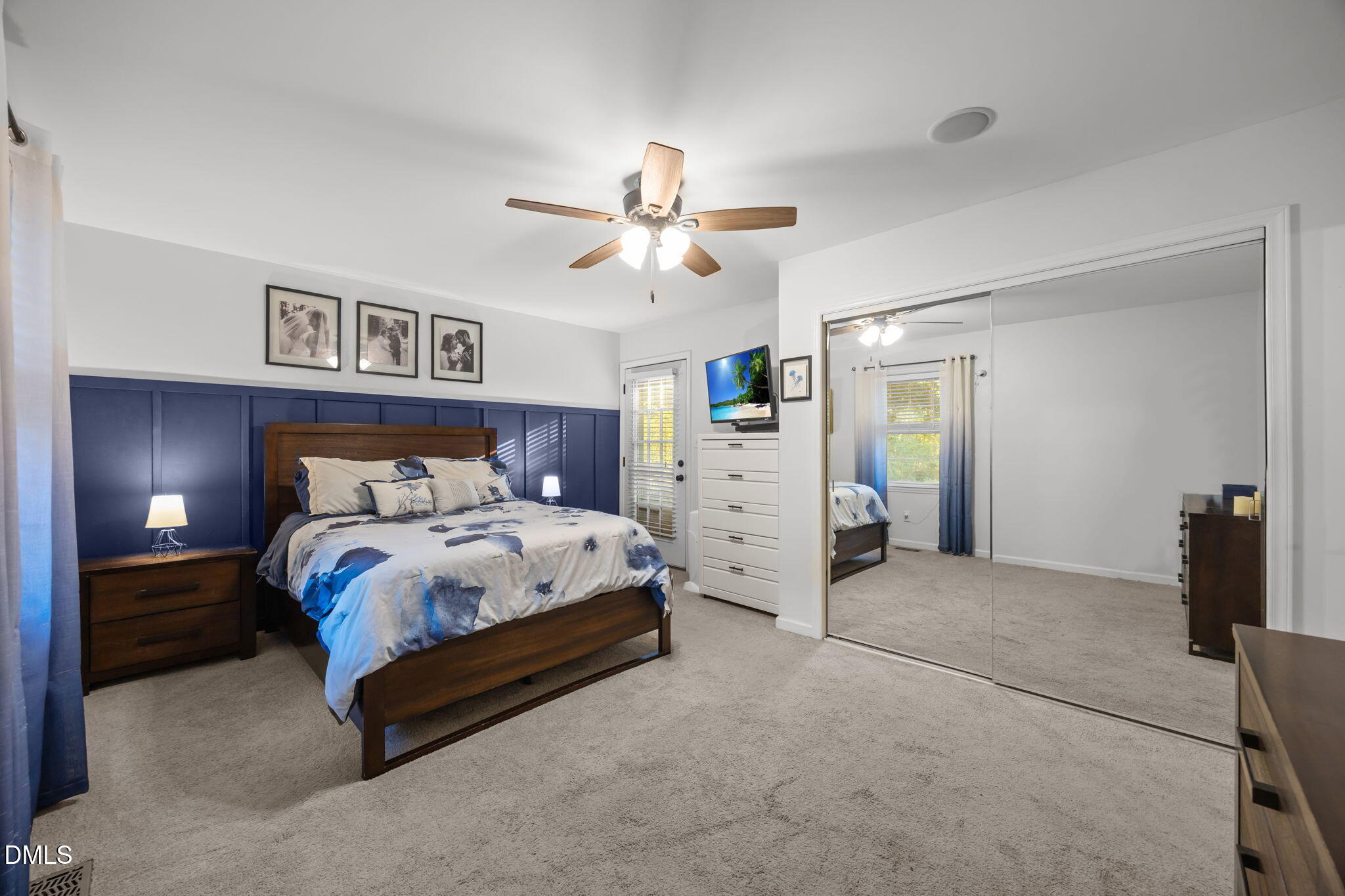 9433 Ferrell Road Zebulon, NC 27597 - Photo 17 of 38 Spacious primary bedroom w/ decorative wall molding, equipped w/ ceiling fan & fully mirrored closet doors!