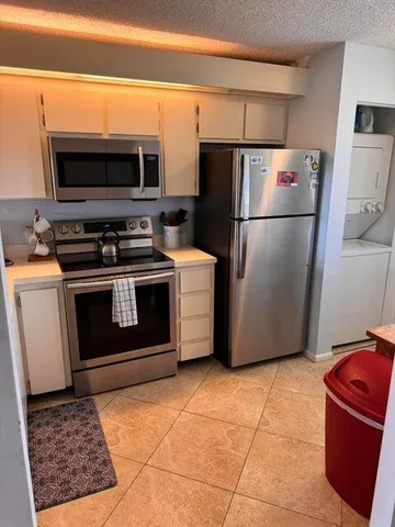 a kitchen with a stove a microwave and a refrigerator