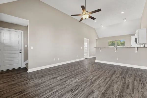 a kitchen with granite countertop a sink cabinets and stainless steel appliances