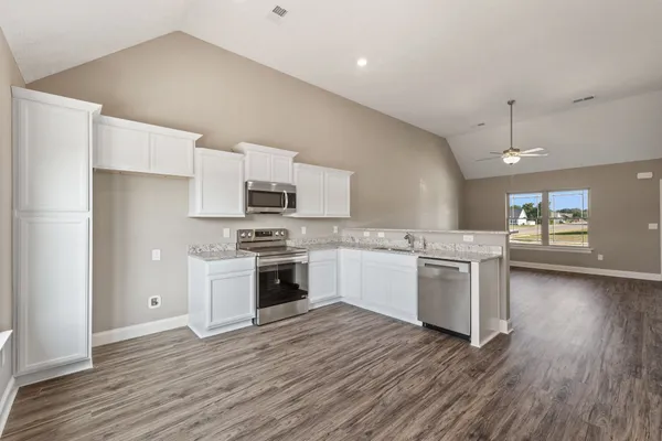 an empty room with closet and a ceiling fan