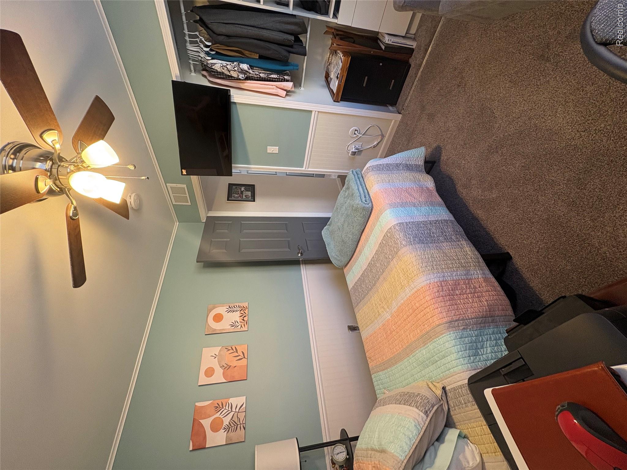 1030 Larson Court Rochester, MI 48307 - Photo 15 of 21 Bedroom featuring a wainscoted wall, crown molding, carpet flooring, a closet, and ceiling fan