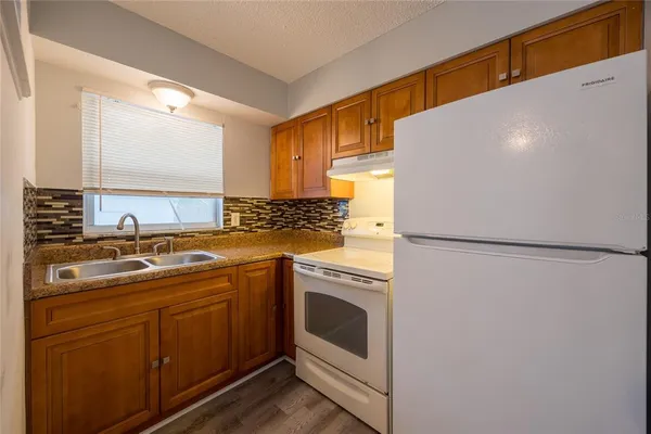 a kitchen with a white cabinets and white appliances