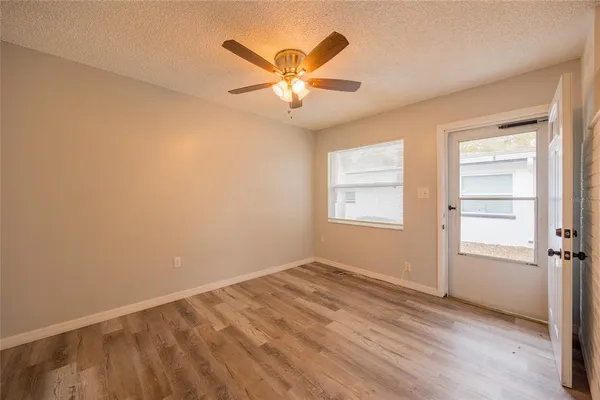 an empty room with closet and windows