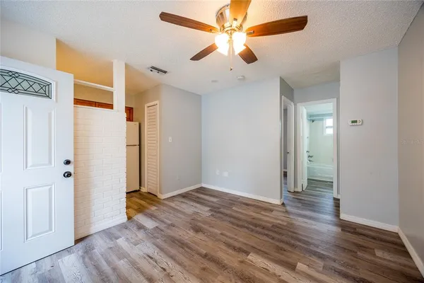 wooden floor in an empty room with a window