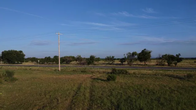 a view of a lake with large trees