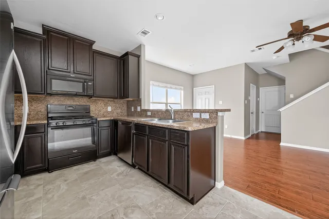 a kitchen with a sink stove and refrigerator