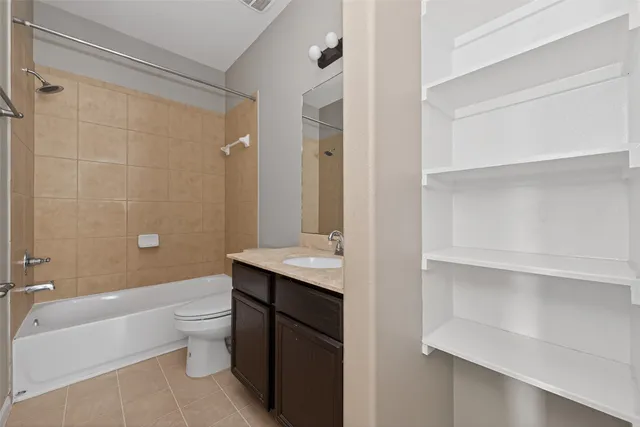 a bathroom with a granite countertop sink toilet a large mirror and shower