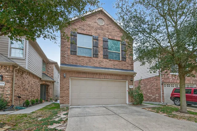 a front view of a house with garage