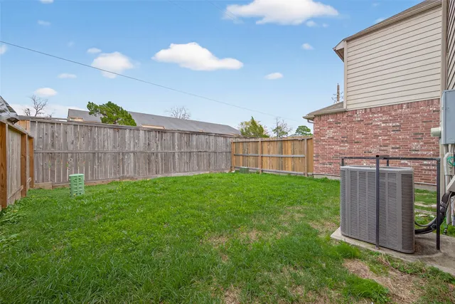 a view of a backyard with wooden fence