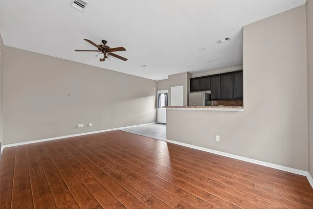 a view of a room with wooden floor and cabinet