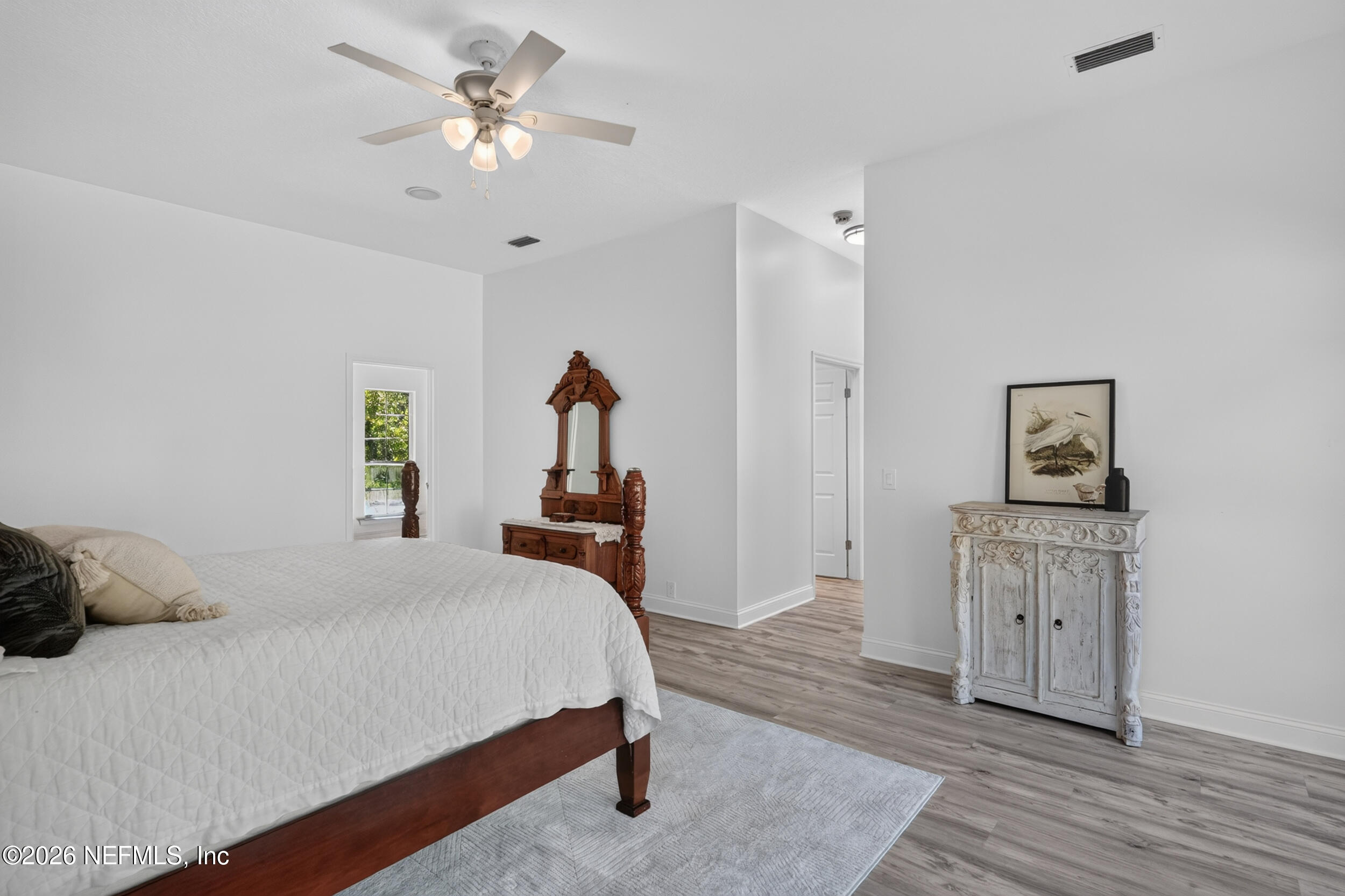 3090 Monument Bay Road St. Augustine, FL 32092 - Photo 23 of 56 a bedroom with a bed and a chandelier