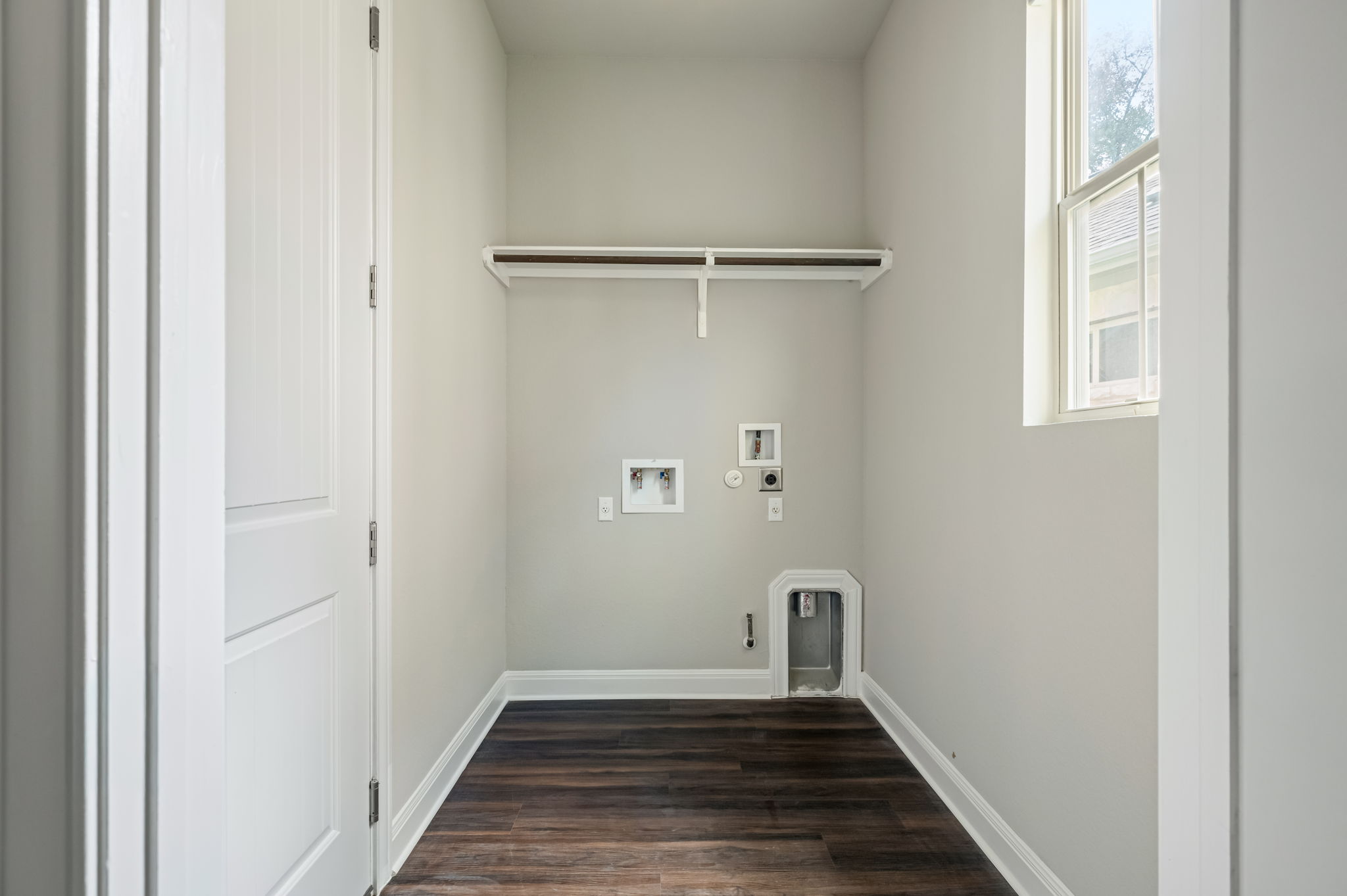 2516 Hopsack Mills Road Austin, TX 78748 - Photo 12 of 39 Dedicated laundry space featuring dark wood-finish flooring and light grey walls